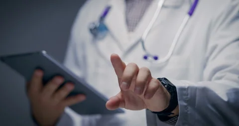 Doctor Using Digital Tablet and Touching Virtual Screen Interface Stock Footage 329183887
