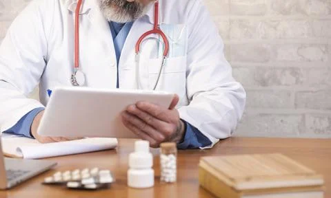 Doctor using digital tablet for online medical consultation Stock Photos