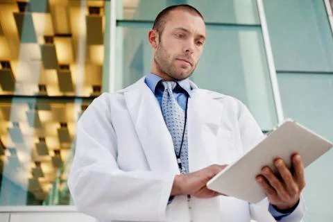Doctor using digital tablet outdoors Stock Photos