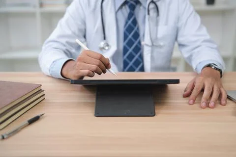 Doctor Using Digital Tablet for Patient Records and Consultations Stock Photos