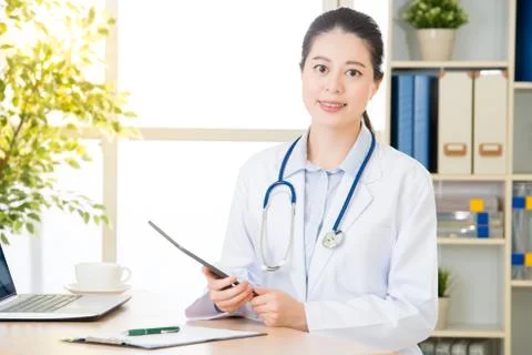 Doctor using digital tablet to research patient's medical case Photos