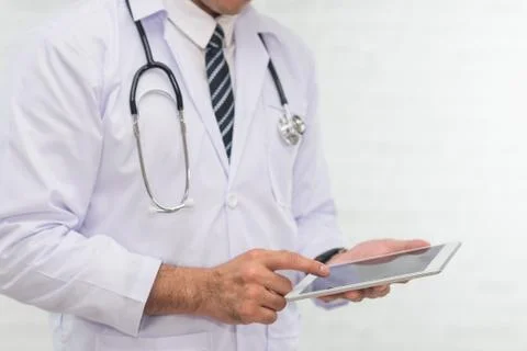 Doctor using digital tablet on white background Stock Photos
