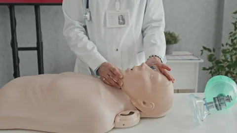 Doctor Using Dummy At CPR Class Stock Footage 223927218