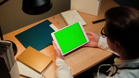 Doctor using gadget tablet with green chroma key screen. Man therapist working Stock Footage 195122424