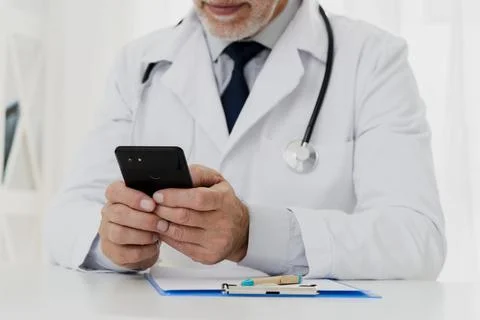 Doctor using his phone Stock Photos