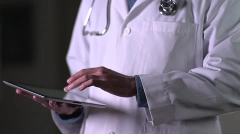 Doctor using iPad, wide shot Stock Footage