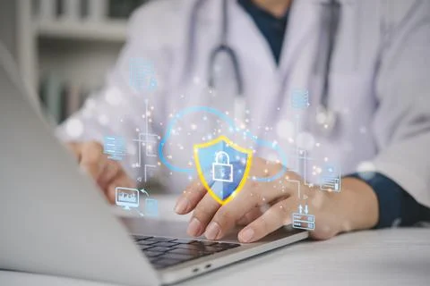 Doctor using laptop with cloud security shield hologram. Medical data prote.. Stockfoto's