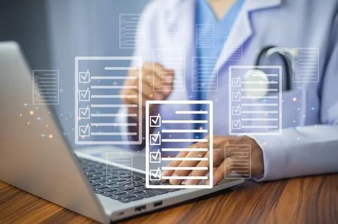 Doctor using laptop for digital document management in office, Stock Photos