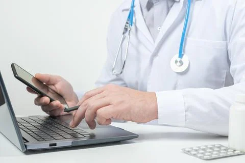 Doctor using laptop for online consultation. Medical doctor working on laptop Stock Photos