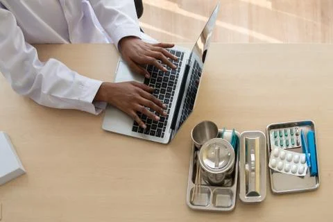 Doctor Using Laptop On Table Stock Photos