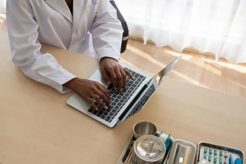 Doctor Using Laptop On Table Stock Photos