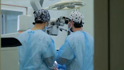 Doctor using microscope during nerve surgery. A professional microsurgeon Stock Photos