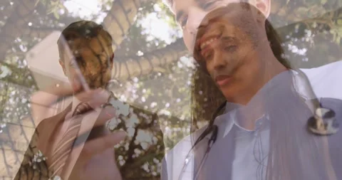 A doctor is using a mobile phone in the backyard of a hospital Stock Footage 330664342