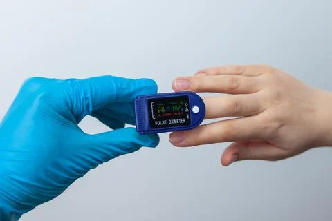 Doctor using pulse oximeter to check patient oxygen saturation Stock Photos