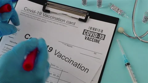 Doctor using red marker cross out covid 19 vaccination document anti vaccine Stock Footage 147442107