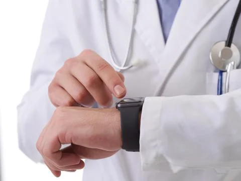 Doctor using smartwatch while checking heartbeat pulse Stock Photos