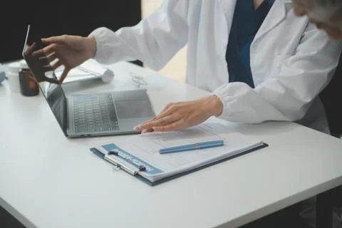 Doctor using sphygmomanometer with stethoscope checking blood pressure to a.. 写真素材