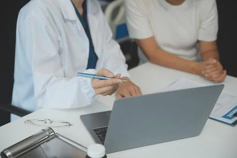 Doctor using sphygmomanometer with stethoscope checking blood pressure to a.. Stock Photos
