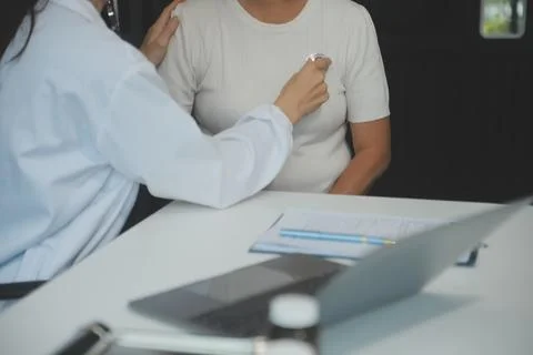Doctor using sphygmomanometer with stethoscope checking blood pressure to a.. Stock Photos