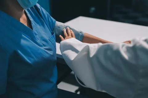 Doctor using sphygmomanometer with stethoscope checking blood pressure to a.. Stock Photos