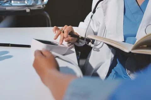 Doctor using sphygmomanometer with stethoscope checking blood pressure to a.. 写真素材