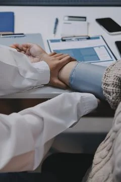 Doctor using sphygmomanometer with stethoscope checking blood pressure to a.. Stock Photos