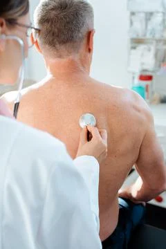 Doctor using stethoscope to check lung function of man Foto stock