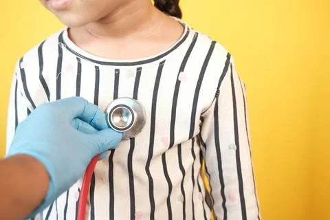Doctor using a stethoscope checking child body, close up 写真素材