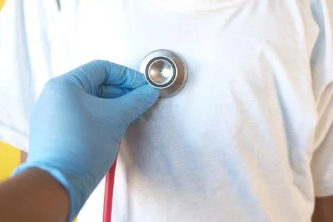 Doctor using a stethoscope checking child body, close up Stock Photos