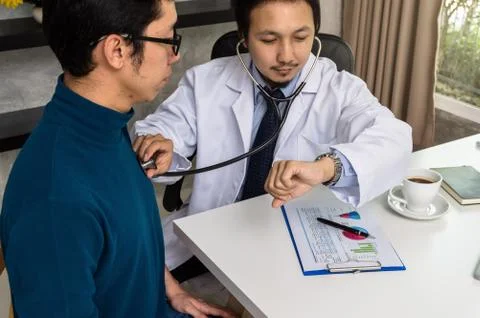 Doctor using stethoscope for checking heart rate and consulting with Patient  Stock Photos