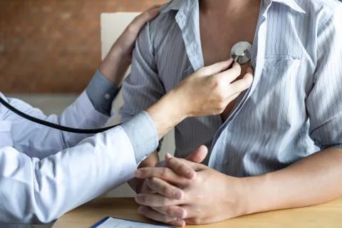Doctor using a stethoscope checking patient with examining, presenting result Stock Photos