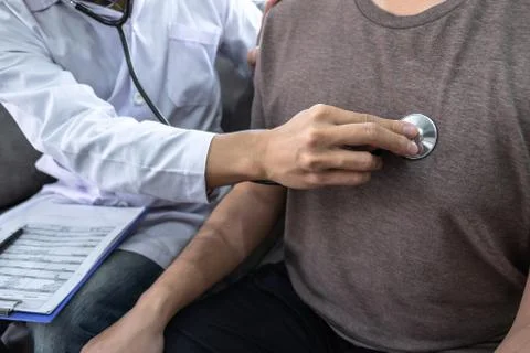 Doctor using a stethoscope checking patient about the problem of illness, sic Stock Photos