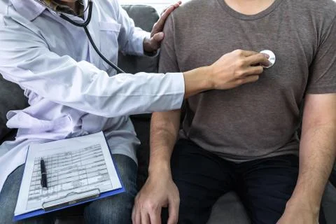 Doctor using a stethoscope checking patient about the problem of illness, sic Stock Photos