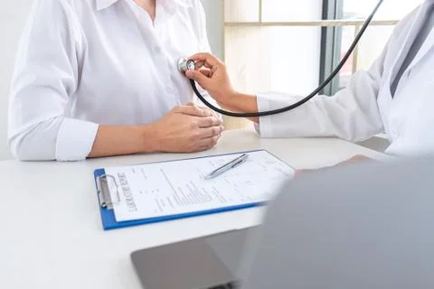 Doctor using a stethoscope checking patient about the problem of illness, sic Stock Photos