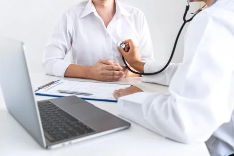 Doctor using a stethoscope checking patient about the problem of illness, sic Stock Photos
