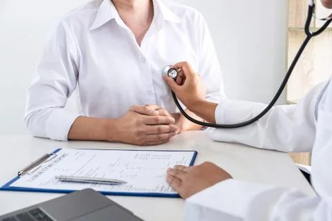 Doctor using a stethoscope checking patient about the problem of illness, sic Stock Photos