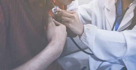 Doctor using a stethoscope checking patient with examining, presenting resu.. Stock Photos