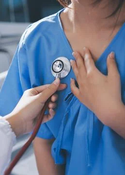 Doctor using a stethoscope checking patient with examining, presenting resu.. Stock Photos