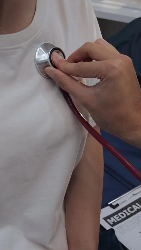 Doctor using a stethoscope to examine a female patient's chest. Medical che.. Stock Footage 340539347