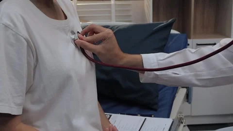 Doctor using a stethoscope to examine a female patient's chest. Medical che.. Stock Footage 340539349
