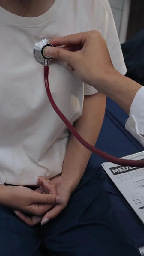 Doctor using a stethoscope to examine a female patient's chest. Medical che.. Stock Footage 340539353