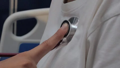 Doctor using a stethoscope to examine a female patient's chest. Medical che.. Video stock 340539363