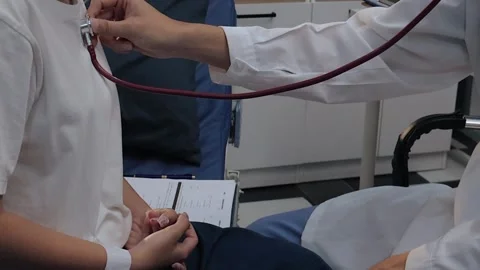 Doctor using a stethoscope to examine a female patient's chest. Medical che.. Stock Footage 340539365