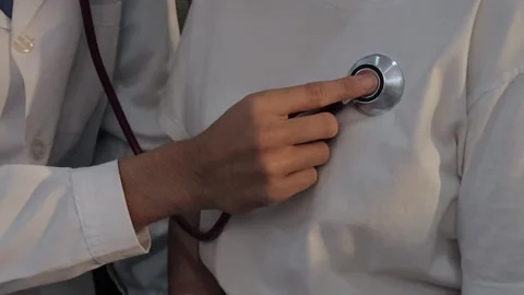 Doctor using a stethoscope to examine a female patient's chest. Medical che.. Stock Footage 340539373
