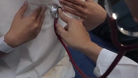 Doctor using a stethoscope to examine a female patient's chest. Medical che.. Stock Footage 340539375