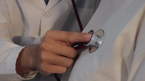 Doctor using a stethoscope to examine a female patient's chest. Medical che.. Stock Footage 340539376