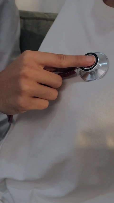 Doctor using a stethoscope to examine a female patient's chest. Medical che.. Stock Footage 340539377