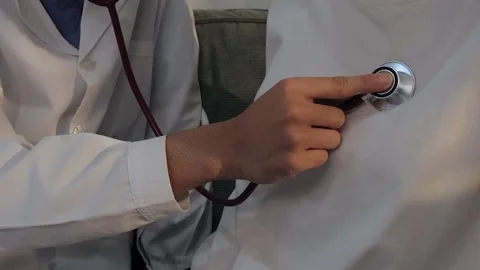 Doctor using a stethoscope to examine a female patient's chest. Medical che.. Stock Footage 340539378