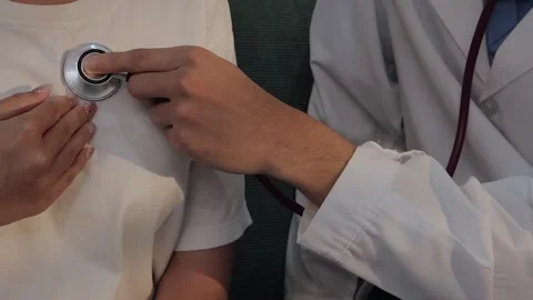 Doctor using a stethoscope to examine a female patient's chest. Medical che.. Stock Footage 340539409