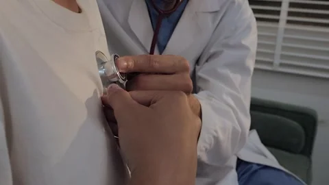 Doctor using a stethoscope to examine a female patient's chest. Medical che.. Stock Footage 340539412